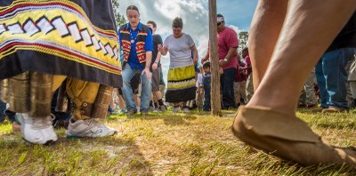 School children dance with Oklahoma Creek Stomp Dancers, during the Poarch Band of Creek Indians Southeastern Indian Festival on Thursday, April 3, 2014, near Atmore, Alabama