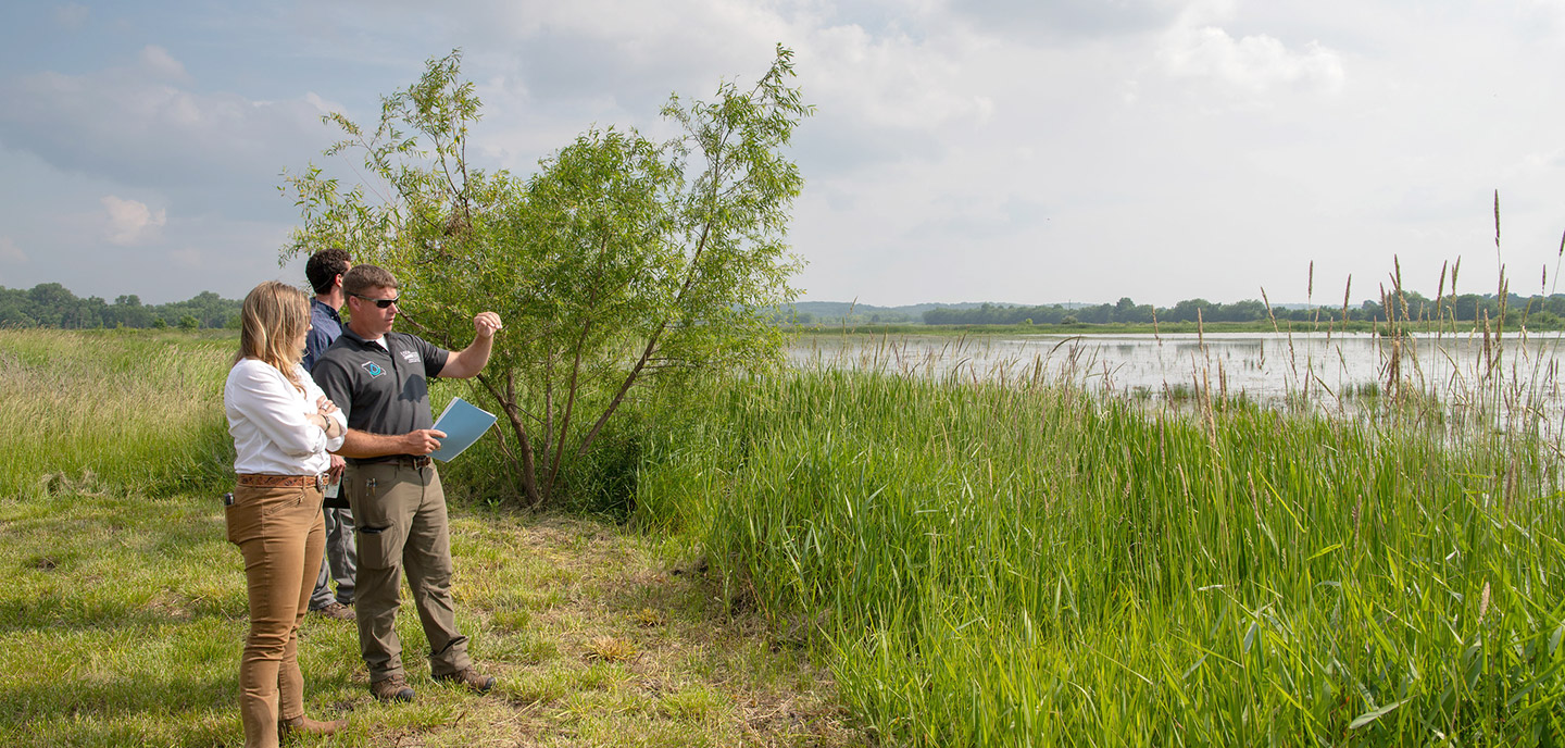 USDA/NRCS people viewing pond